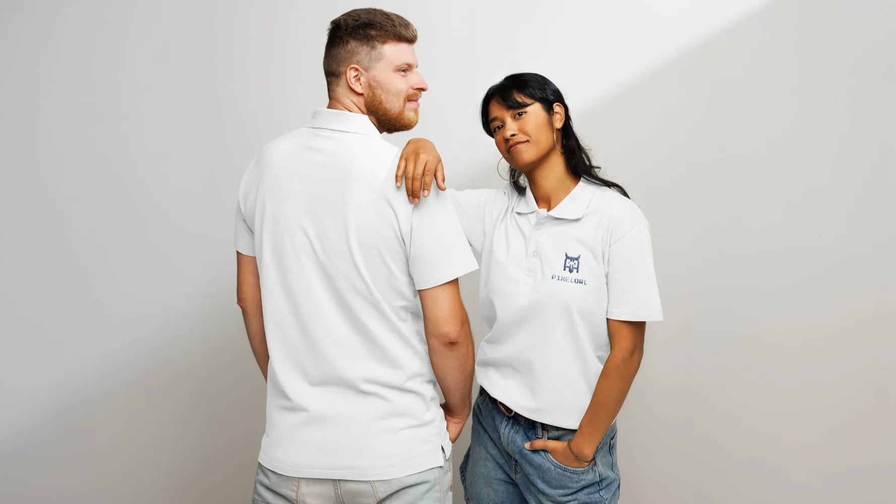 Two people wearing white custom polo shirts with an embroidered logo